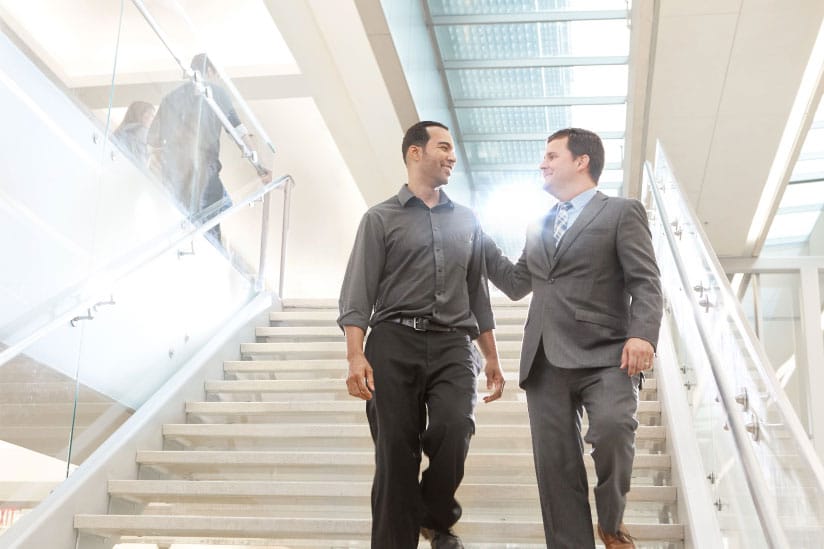 Attorney Bradley Groene walking down stairs with a happy client